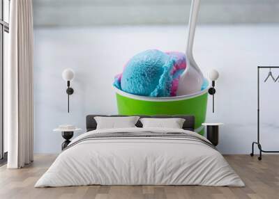 A view of a cup of rainbow ice cream scoops. Wall mural