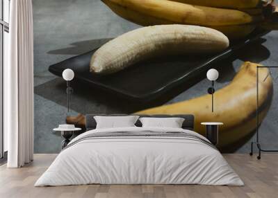 A view of a peeled banana on a plate. Wall mural