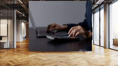 Businessman using calculator to calculate business financial cost,  Wall mural