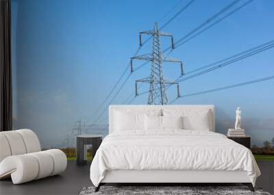 Electricity pylons in a field with blue sky. Bishop's Stortford, Hertfordshire. UK Wall mural