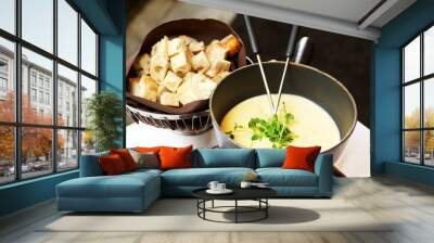 Cheese fondue plate with bread at a restaurant. Wall mural