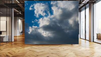 Clouds in bright sunlight. Nimbostratus clouds in sunlight. Blue sky and white clouds in bright sunlight. Wall mural