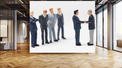 two business figurines shaking hands Wall mural