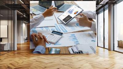 Cropped shot of diverse coworkers working together in a boardroom, working by digital tablet management big data analyze business discussing brainstorming analyzing strategy financial document  Wall mural