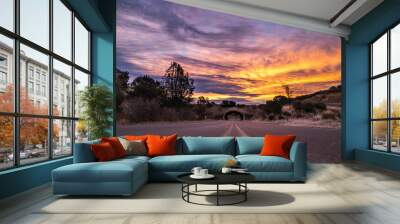 Tunnel on a rural road in Northern California at sunrise with colorful clouds Wall mural