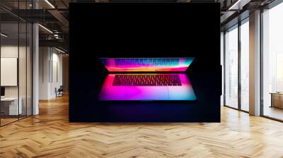 Isolated high tech open laptop with abstract vibrant color screen on a dark background. Wall mural