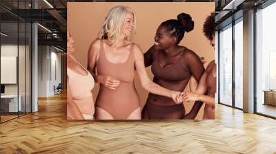 Diversity, women and skincare for body positivity, cosmetics or conversation on brown studio background. Health females and multiracial ladies with confidence, wellness or talking with smile or laugh Wall mural