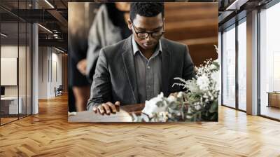 Funeral coffin, death and black man sad, grieving and mourning loss of family, friends or dead loved one. Church service, floral flowers and person with casket, grief and sadness over loss of life Wall mural