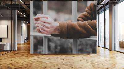 Man's hand on metal bars - no freedom concept Wall mural