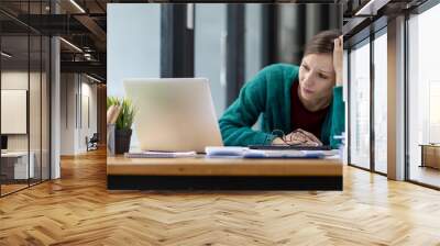 Portrait of sad depressed tired woman bored while working in the office workplace. Wall mural