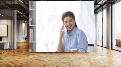 Portrait of tired young business Asian woman work with documents tax laptop computer in office. Sad, unhappy, Worried, Depression, or employee life stress concept Wall mural