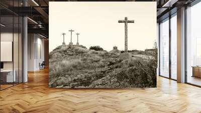 three crosses carved in the stone on fund to the evening Wall mural