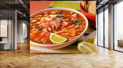 A bowl of chicken and tortilla soup with lime Wall mural