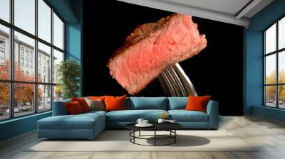 A piece of grilled ribeye steak on a fork Wall mural