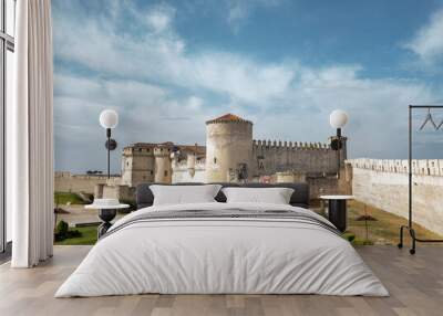 Landscape of the Cuellar Castle surrounded by greenery under a blue cloudy sky in Spain Wall mural