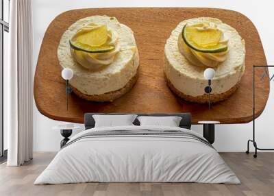 Top-down view of lemon cheesecakes on a wooden plate Wall mural