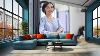 Young asian woman, professional entrepreneur standing in office clothing, smiling and looking confident, workplace office background Wall mural