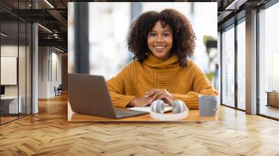 Young beautiful african student girl working, learning in computer and device studying online. Wall mural