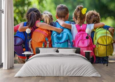 A group of kids with colorful backpacks Hugging together for back to school day. Wall mural