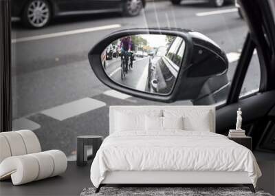 Cyclist in the exterior mirror of a car Wall mural