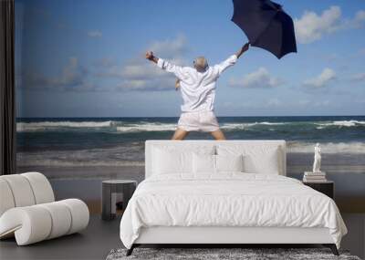 Happy businessman on a beautiful tropical beach Wall mural