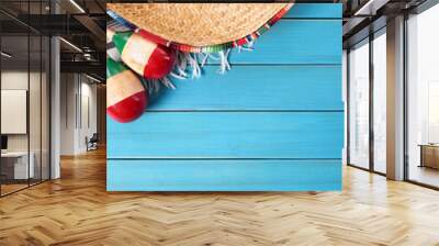 mexican background with sombrero straw hat maracas and traditional serape rug or blanket on old blue Wall mural