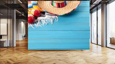 Mexican background with sombrero straw hat maracas and traditional serape rug or blanket on old planked blue wood Mexico holiday vacation cinco de mayo photo  Wall mural