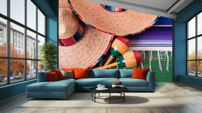 Mexico cinco de mayo fiesta carnival traditional green wood mexican sombrero maracas and serape rug or blanket photo Wall mural