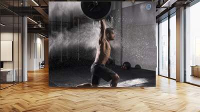 Man Holding a Weight in the Gym Wall mural