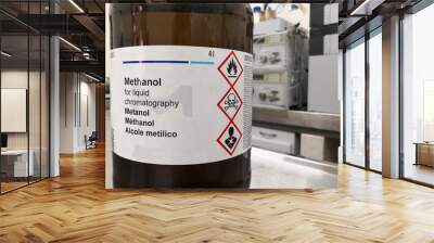 Amber glass bottle for lightning protection containing methanol, an HPLC grade alcohol, and a label with GHS warnings about toxicity, flammability and death. Chemical reagent in a scientific research  Wall mural