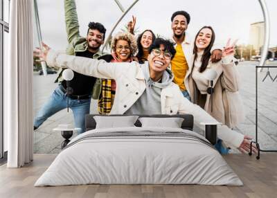 Big group of happy friends stands together on city street with raised arms - Multiracial young people having fun outside - Volunteer with hands up showing teamwork spirit - Community and friendship. Wall mural