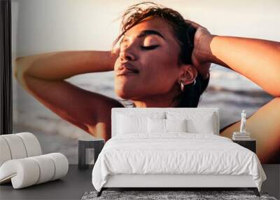 Cheerful black woman enjoying sunset on the beach - African female with closed eyes relaxing outdoor  Wall mural