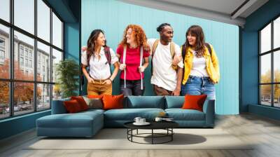 Diverse college students standing together on a blue wall - Photo portrait of multiracial teenagers in front of university building - Life style concept with guys and girls going to highschool Wall mural