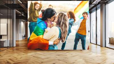 Diverse group of young people celebrating gay pride festival day - Lgbt community concept with two girls kissing outdoors - Multiracial trendy friends standing on a yellow background Wall mural