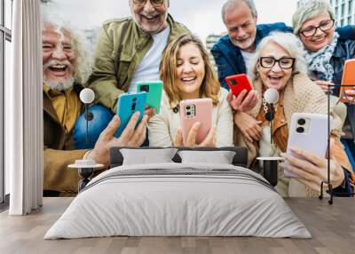 Group of senior people using technology devices together - Happy older friends having fun watching funny video on smartphone - Tech and modern elderly concept Wall mural