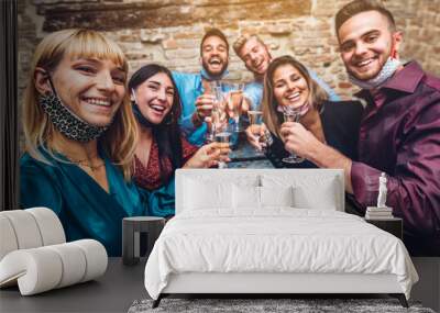 Group of young people enjoying time drinking champagne at restaurant with face mask - New normal concept of happy friends having fun   Wall mural