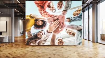 Group of young people stacking hands together outdoor - Community of multiracial international people supporting each other - Union, support and human resources concept Wall mural