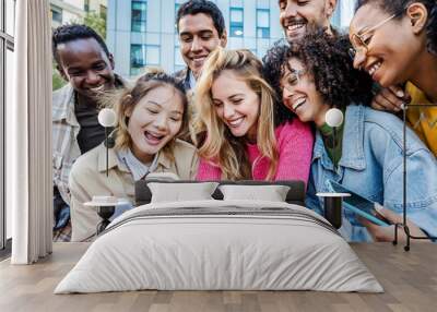 Group of young people using smart mobile phone outdoors - Happy friends with smartphone laughing together watching funny video on social media platform - Tech and modern life style concept Wall mural