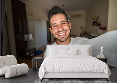 Handsome caucasian man taking a selfie portrait indoor at home - Happy guy smiling at the camera. Wall mural