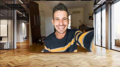 Handsome caucasian man taking a selfie portrait indoor at home - Happy guy smiling at the camera. Wall mural