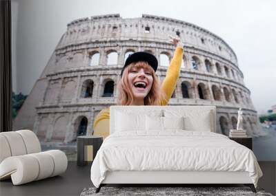 Happy beautiful young woman take a selfie at the Colosseum in Rome, Italy. Wall mural