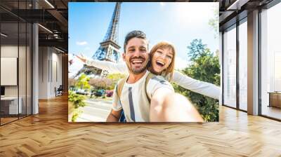 Happy couple of tourists taking selfie picture in front of Eiffel Tower in Paris, France - Travel and summer vacation life style concept Wall mural