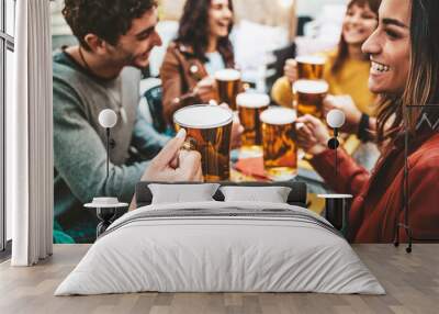 Happy friends enjoying happy hour drinking beer at brewery pub - Group of young people hanging out dining together at bar restaurant - Beverage lifestyle and friendship concept Wall mural