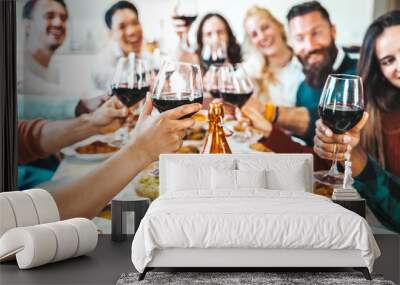 Happy friends toasting red wine glasses at dinner party - Group of people having lunch break at bar restaurant - Life style concept with guys and girls hanging out together - Food and beverage Wall mural