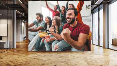 Happy friends watching soccer world cup on television at home Wall mural