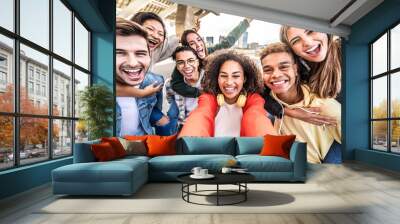 Happy multiracial friends taking selfie pic outdoors - Group of young people smiling together at camera on city street - University students having fun in college campus - Youth community concept Wall mural