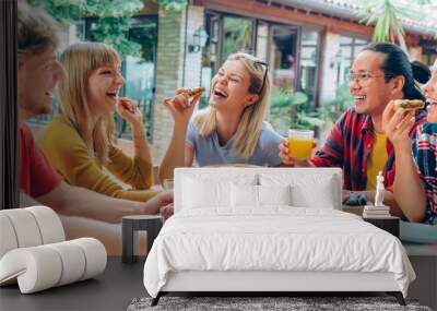 Happy young people eating healthy food at farm house picnic - Life style concept with cheerful woman and man drinking fresh orange juice sitting at cafe bar table - Food and beverage Wall mural