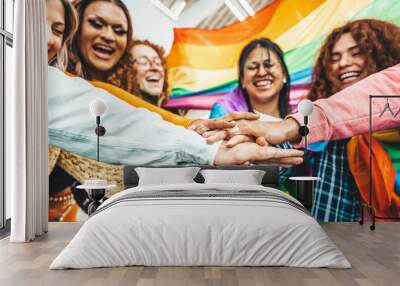 Lgbt group of people stacking hands outside - Diverse happy friends hugging outdoors - Gay pride concept with crowd of guys and girls standing together on city street Wall mural