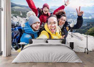 Millenial friends taking selfie on the top of the mountain - Young people on a hiking trip celebrate reaching the summit - Hikers climbing cliff together Wall mural