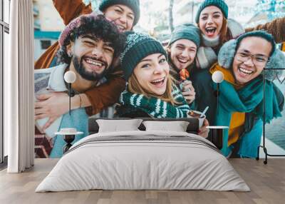 Multicultural friends wearing winter clothes enjoying winter vacation together - Happy young people celebrating new year eve - Friendship and winter holidays concept Wall mural